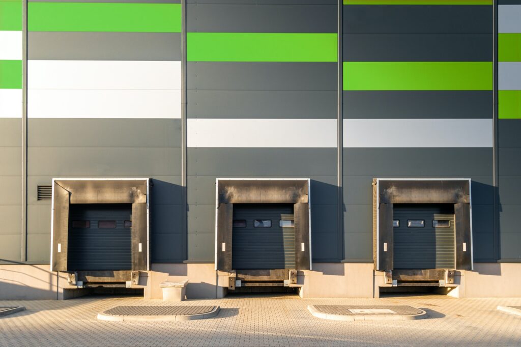 Cargo loading dock doors of big warehouse building, outdoor